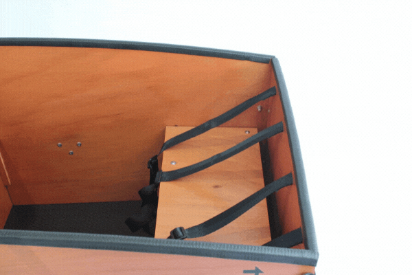 The front bench of a Tribe Original cargo box folding up to free the space