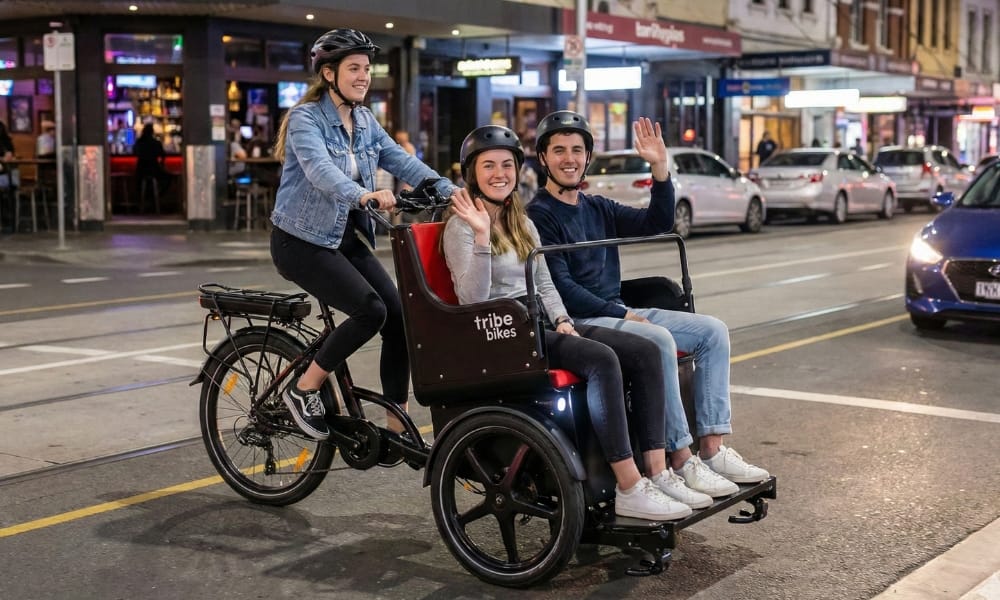 A tour operator carrying passengers in a Ricky Rickshaw